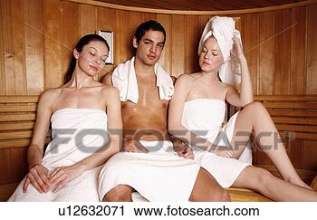 Stock Photography - man with two young 
women enjoying 
a sauna. fotosearch 
- search stock 
photos, pictures, 
images, and photo 
clipart