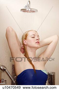 Stock Photograph - woman taking a 
shower at the 
gym. fotosearch 
- search stock 
photos, pictures, 
images, and photo 
clipart