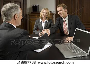 Stock Photo - couple in business 
meeting and shaking 
hands with businessman. 
fotosearch - search 
stock photos, 
pictures, images, 
and photo clipart