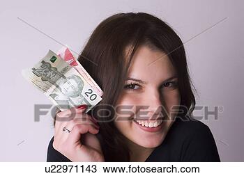 Stock Photo - female model holding 
canadian currency. 
fotosearch - search 
stock photos, 
pictures, images, 
and photo clipart