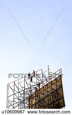 Picture - indian construction 
workers putting 
up a giant advertisement 
without. fotosearch 
- search stock 
photos, pictures, 
images, and photo 
clipart