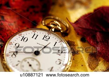Stock Photography - time passages 
- an old pocket 
watch on top of 
autumn leaves 
portrays. fotosearch 
- search stock 
photos, pictures, 
images, and photo 
clipart