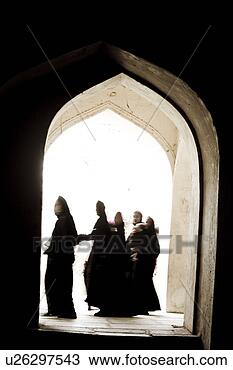 Stock Photo - woman walk by 
an open doorway 
in ancient tomb 
in hyderabad india. 
fotosearch - search 
stock photos, 
pictures, images, 
and photo clipart