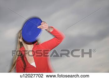 Stock Photo - woman playing 
with a frisbee, 
 throwing and 
catching,  in 
front of. fotosearch 
- search stock 
photos, pictures, 
images, and photo 
clipart