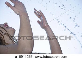 Stock Image - young woman refreshing 
herself by splashing 
water all over 
her body. fotosearch 
- search stock 
photos, pictures, 
images, and photo 
clipart