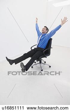 Stock Photography - man speeds through 
office on chair. 
fotosearch - search 
stock photos, 
pictures, images, 
and photo clipart