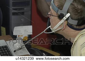 Stock Photograph - man with significant 
disabilities using 
headgear to operate. 
fotosearch - search 
stock photos, 
pictures, images, 
and photo clipart