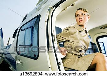 Stock Photo - a woman sitting 
in a helicopter. 
fotosearch - search 
stock photos, 
pictures, images, 
and photo clipart