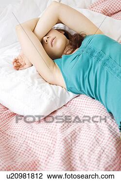 Stock Photo - exhausted teenage 
girl sleeping 
on bed. fotosearch 
- search stock 
photos, pictures, 
images, and photo 
clipart
