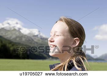 Picture - girl sitting in 
mountain scenery. 
fotosearch - search 
stock photos, 
pictures, images, 
and photo clipart