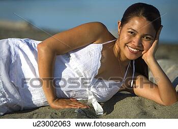 Stock Photo - woman laying on 
the beach. fotosearch 
- search stock 
photos, pictures, 
images, and photo 
clipart