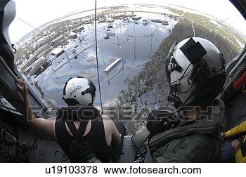 Stock Photo - a search and rescue 
(sar) swimmer 
assists in a rescue 
of a hurricane. 
fotosearch - search 
stock photos, 
pictures, images, 
and photo clipart