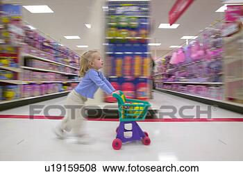 Stock Photo - toddler pushing 
a play shopping 
cart along the 
toy aisles. fotosearch 
- search stock 
photos, pictures, 
images, and photo 
clipart