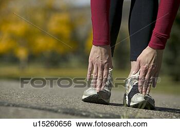 Stock Photo - stretching in 
preparation for 
a jog. fotosearch 
- search stock 
photos, pictures, 
images, and photo 
clipart