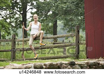 Stock Photo - gardener sitting  on wooden fence.  fotosearch - search  stock photos,  pictures, images,  and photo clipart