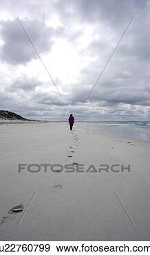 Stock Photograph - lonely woman walking 
along beach. fotosearch 
- search stock 
photos, pictures, 
images, and photo 
clipart