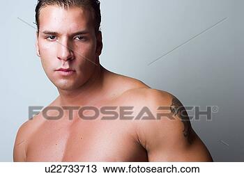 Stock Photo - male fitness model 
with tattoo on 
arm. fotosearch 
- search stock 
photos, pictures, 
images, and photo 
clipart