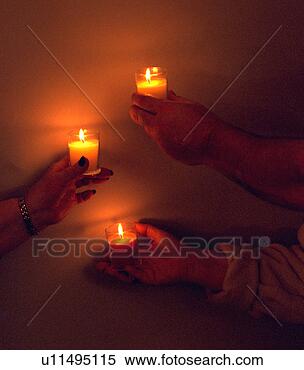 Stock Image - three hands holding 
lighted candles. 
fotosearch - search 
stock photos, 
pictures, images, 
and photo clipart