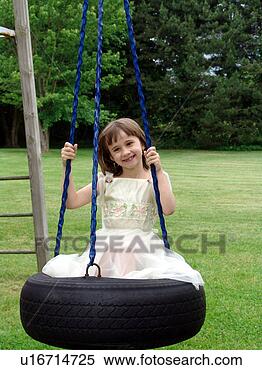 Stock Image - girl on tire swing. 
fotosearch - search 
stock photos, 
pictures, images, 
and photo clipart