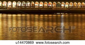 Stock Photograph - lights from boardwalk 
promenade reflecting 
on water at night. 
fotosearch - search 
stock photos, 
pictures, images, 
and photo clipart