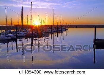 Stock Photography - marina sunrise 
over calm reflective 
water. fotosearch 
- search stock 
photos, pictures, 
images, and photo 
clipart