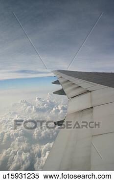 Stock Image - heavy jet airplane 
wing in flight. 
fotosearch - search 
stock photos, 
pictures, images, 
and photo clipart