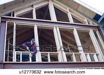 Stock Photo - carpenter framing 
windows in the 
wall during construction 
of a house. fotosearch 
- search stock 
photos, pictures, 
images, and photo 
clipart