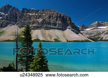 Stock Image - turquoise bow 
lake with crowfoot 
mountains. fotosearch 
- search stock 
photos, pictures, 
images, and photo 
clipart
