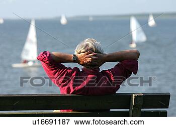 Picture - relaxing on the 
beach viewing 
yachts. fotosearch 
- search stock 
photos, pictures, 
images, and photo 
clipart