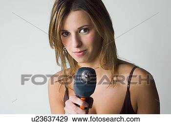 Stock Photograph - female model holding 
small drill. fotosearch 
- search stock 
photos, pictures, 
images, and photo 
clipart