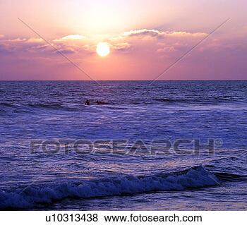 Stock Photo - the sun about 
to set at the 
beach. fotosearch 
- search stock 
photos, pictures, 
images, and photo 
clipart