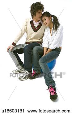 Stock Photography - asian girl and 
boy sitting on 
blue stool in 
studio. fotosearch 
- search stock 
photos, pictures, 
images, and photo 
clipart