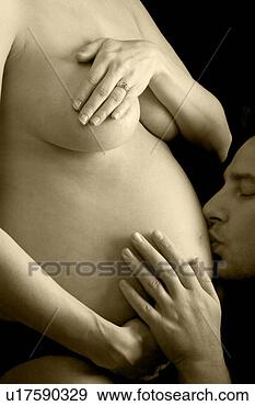 Stock Photograph - early pregnancy 
- man kissing 
wifes belly. fotosearch 
- search stock 
photos, pictures, 
images, and photo 
clipart