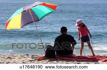 Stock Photography - family and beach 
umbrella. fotosearch 
- search stock 
photos, pictures, 
images, and photo 
clipart