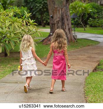 Stock Photography - two young girls 
walking hand in 
hand at moorea 
in tahiti. fotosearch 
- search stock 
photos, pictures, 
images, and photo 
clipart