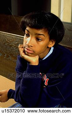 Stock Photography - girl age 13 thinking 
in church pew 
with chin in hand. 
fotosearch - search 
stock photos, 
pictures, images, 
and photo clipart