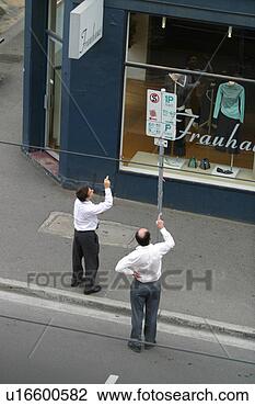Stock Photo - businessmen attempting 
to figure out 
parking sign. 
fotosearch - search 
stock photos, 
pictures, images, 
and photo clipart