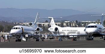 Stock Photography - small commuter 
jets sitting on 
the tarmac. fotosearch 
- search stock 
photos, pictures, 
images, and photo 
clipart