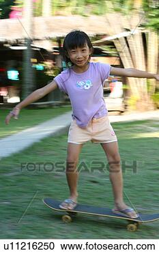 Stock Photography - chinese girl learning 
skate board. fotosearch 
- search stock 
photos, pictures, 
images, and photo 
clipart