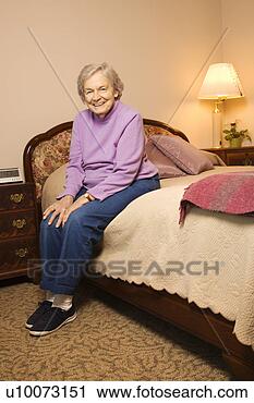 Stock Photography - elderly woman 
in her bedroom 
at retirement 
community center. 
fotosearch - search 
stock photos, 
pictures, images, 
and photo clipart