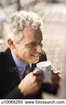 Stock Photo - selective focus 
close up of adult 
caucasian man 
in suit drinking. 
fotosearch - search 
stock photos, 
pictures, images, 
and photo clipart