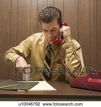 Stock Photo - caucasian mid-adult 
retro businessman 
sitting at desk 
talking on. fotosearch 
- search stock 
photos, pictures, 
images, and photo 
clipart