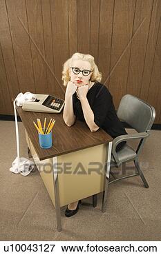 Picture - mid-adult caucasian 
female in vintage 
outfit sitting 
at desk with. 
fotosearch - search 
stock photos, 
pictures, images, 
and photo clipart