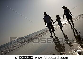 Stock Photo - family on beach 
walking together. 
fotosearch - search 
stock photos, 
pictures, images, 
and photo clipart