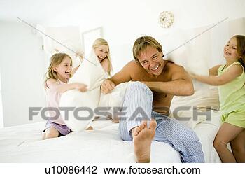 Stock Photo - family at home 
having pillow 
fight. fotosearch 
- search stock 
photos, pictures, 
images, and photo 
clipart
