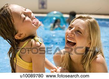 Stock Photography - mother and daughter 
playing in pool. 
fotosearch - search 
stock photos, 
pictures, images, 
and photo clipart