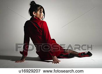 Picture - young woman in 
red sitting down, 
rear view. fotosearch 
- search stock 
photos, pictures, 
images, and photo 
clipart