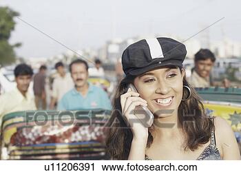 Stock Photography - young woman talking 
on a mobile phone. 
fotosearch - search 
stock photos, 
pictures, images, 
and photo clipart