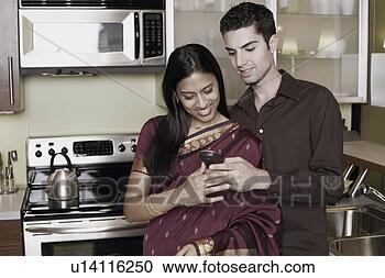 Stock Photography - close-up of a 
young man showing 
a young woman 
a mobile phone. 
fotosearch - search 
stock photos, 
pictures, images, 
and photo clipart