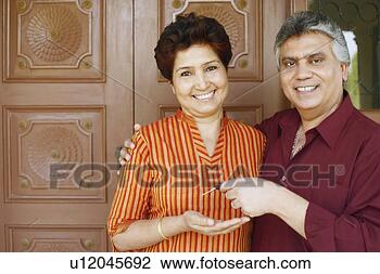 Stock Photo - portrait of a 
mature man giving 
his car keys to 
a mature woman. 
fotosearch - search 
stock photos, 
pictures, images, 
and photo clipart